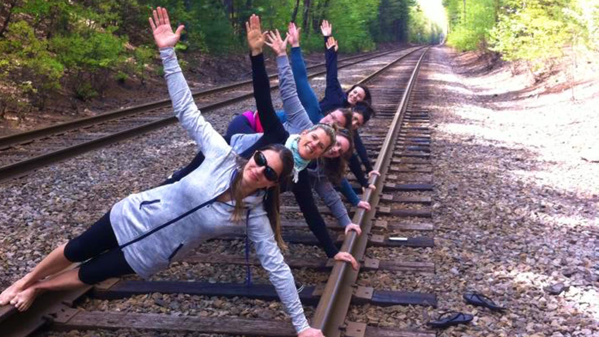 Yoga teacher training class outdoors at train tracksat Advanced Health Massage and Yoga